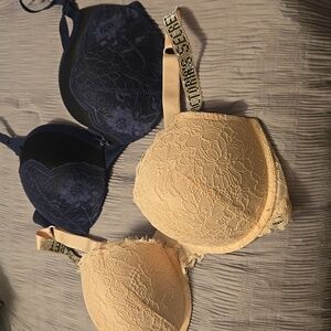 Victoria Secret rhinestone strap light pink bra and Maidenform Navy lace bra 36D